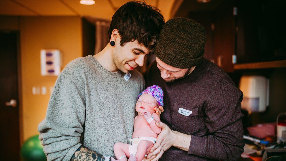 Matthew Eledge and partner Elliot holding daughter