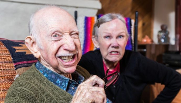elderly couple showing teeth grimacing