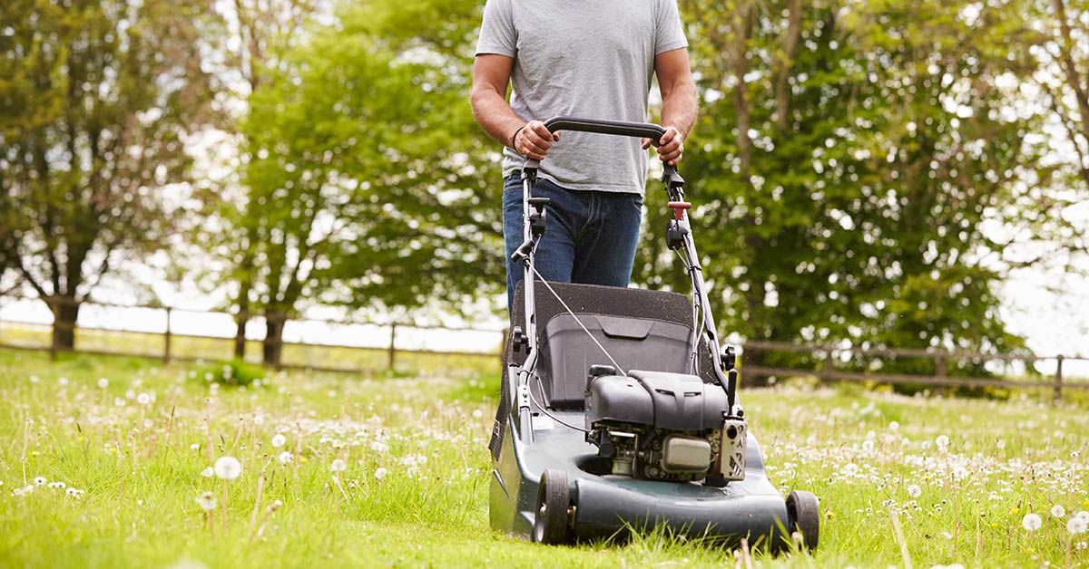 man mowing lawn with lawnmower