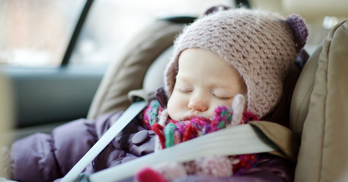 child in car seat wearing winter clothing