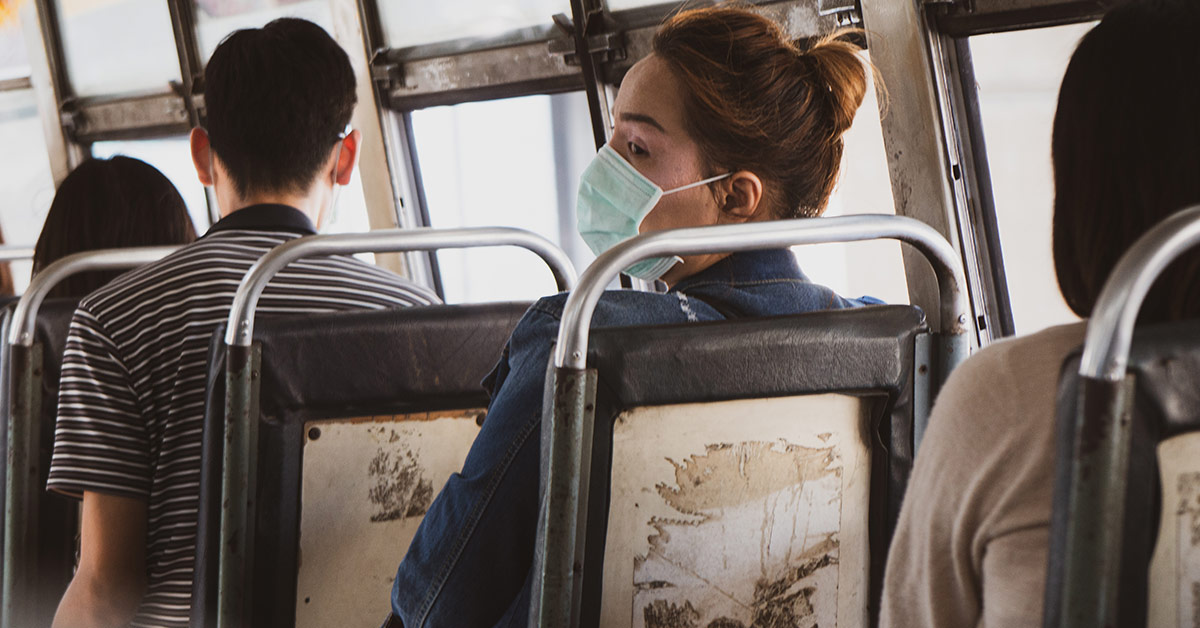 woman on bus wearing mask