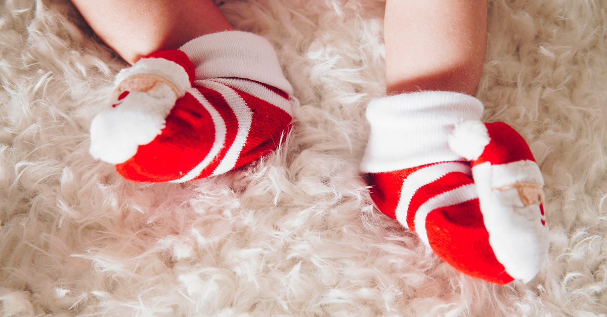 infant wearing christmas themed socks