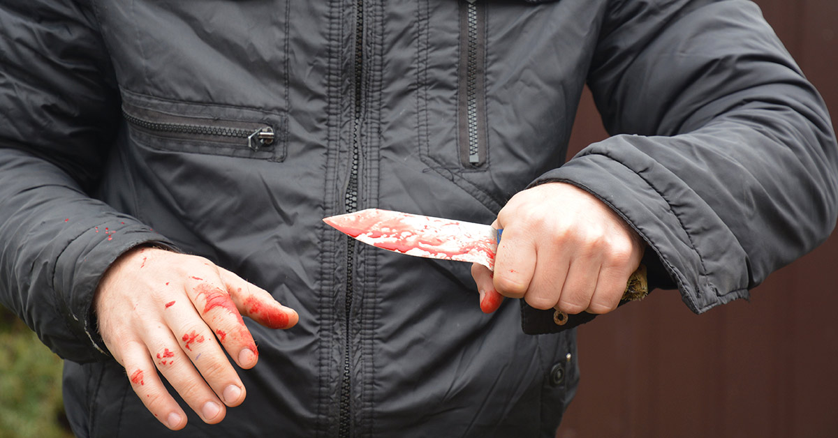 attacker holding bloody knife