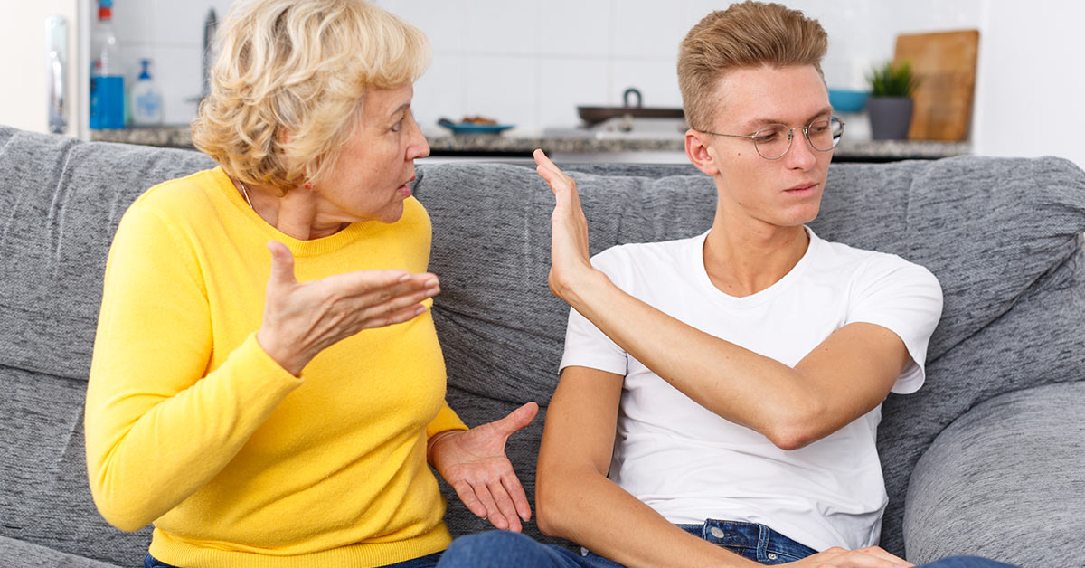 mother and son in argument while sitting on a couch