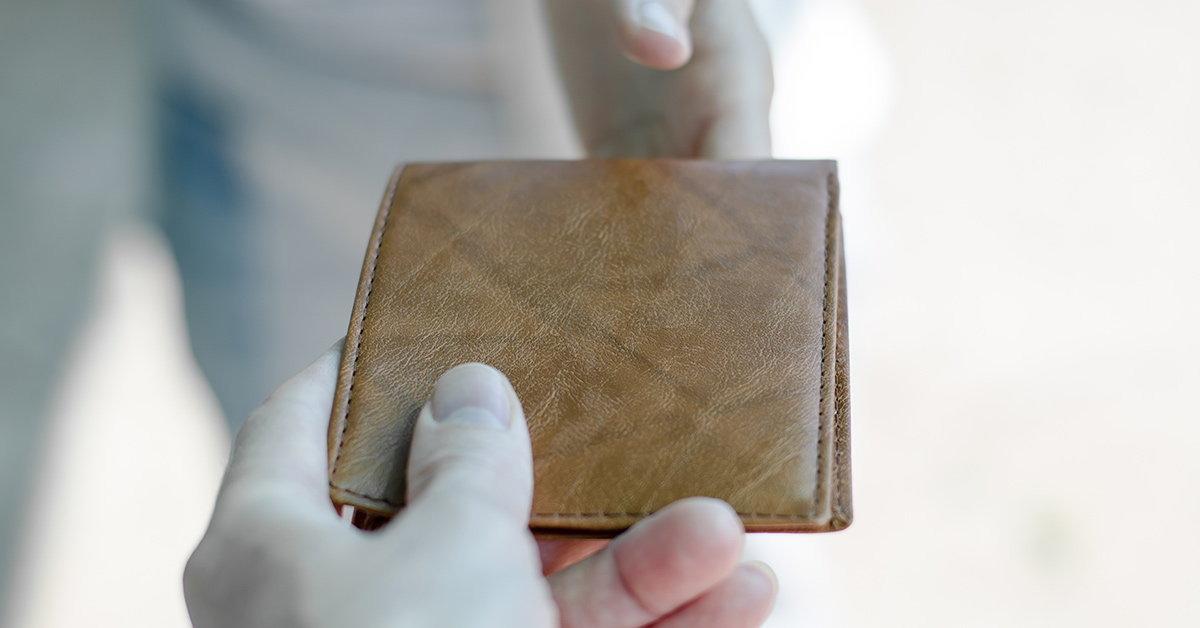 wallet being handed from one person to another