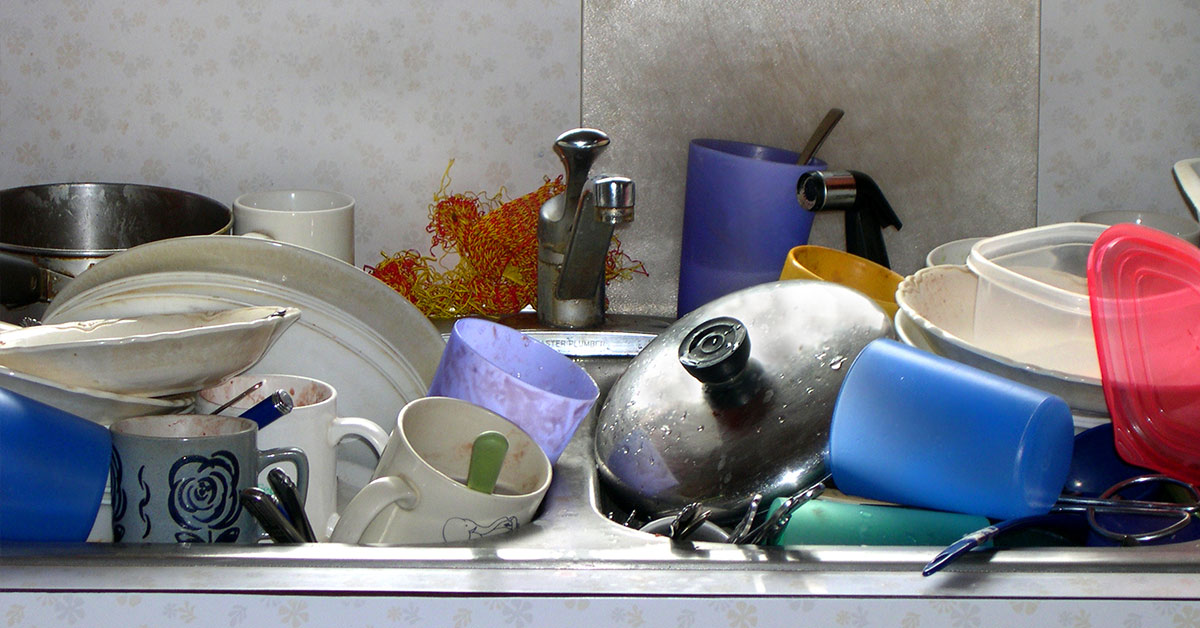 sink full of unwashed dishes