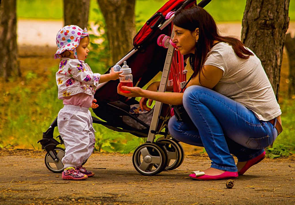 A mother and her baby outside with their stroller