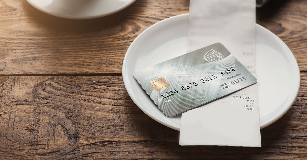 credit card placed on a plate at a restaurant