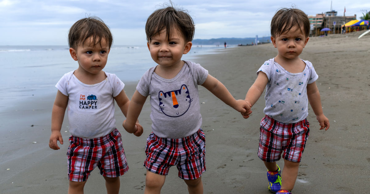 triplets on a beach