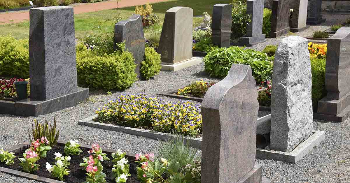 a cemetary with with well manicured flowers and lawn